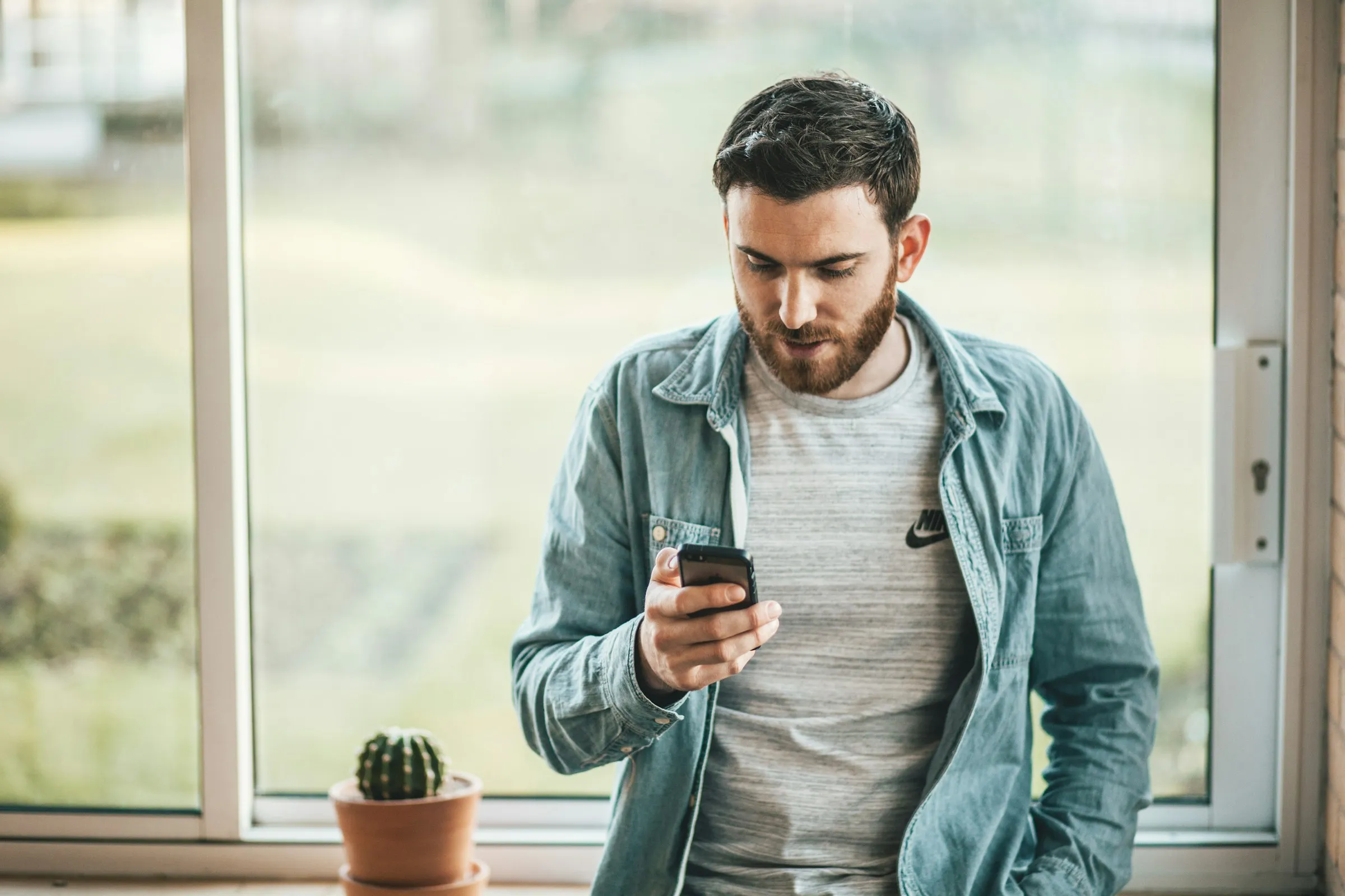 A homeowner checking a phone, waiting to hear back